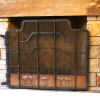 Wrought iron fire screen with copper panels and trees in repoussé